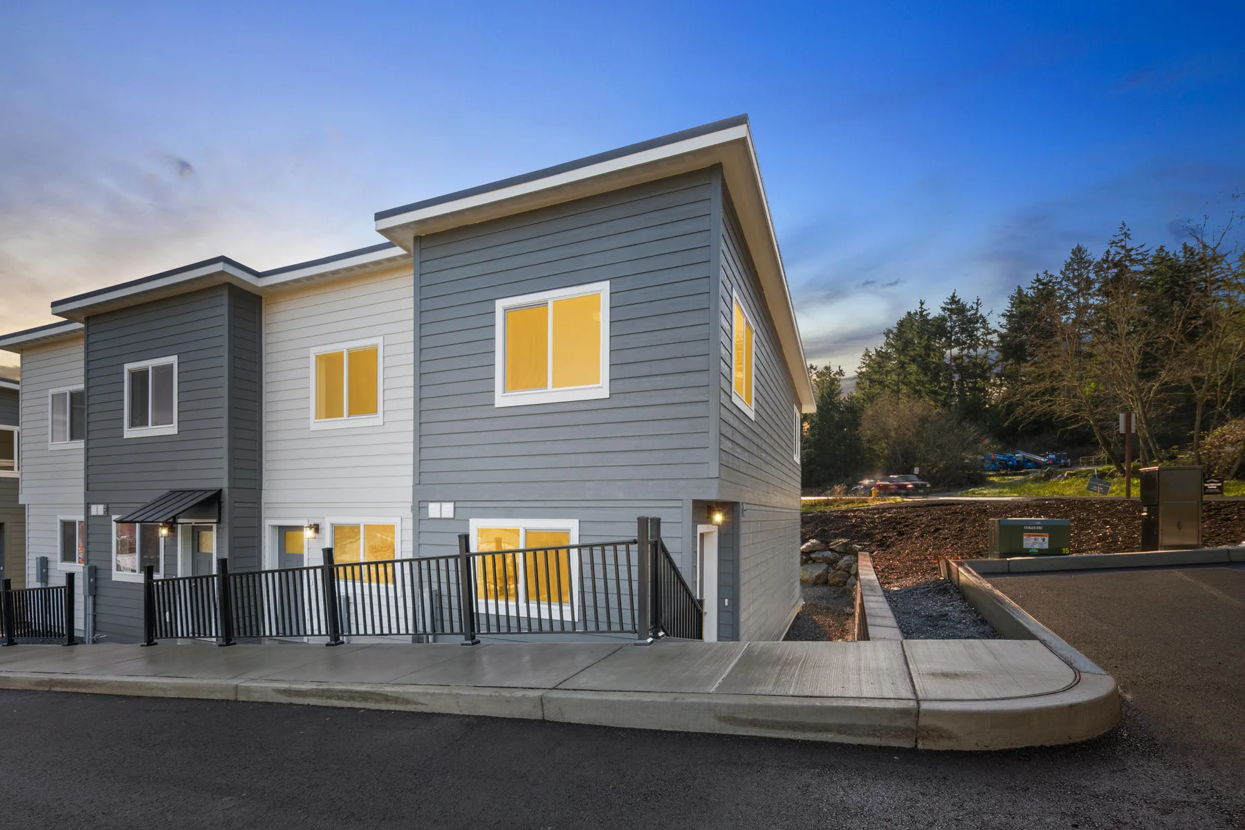 Digitally created twilight view of the townhome exterior