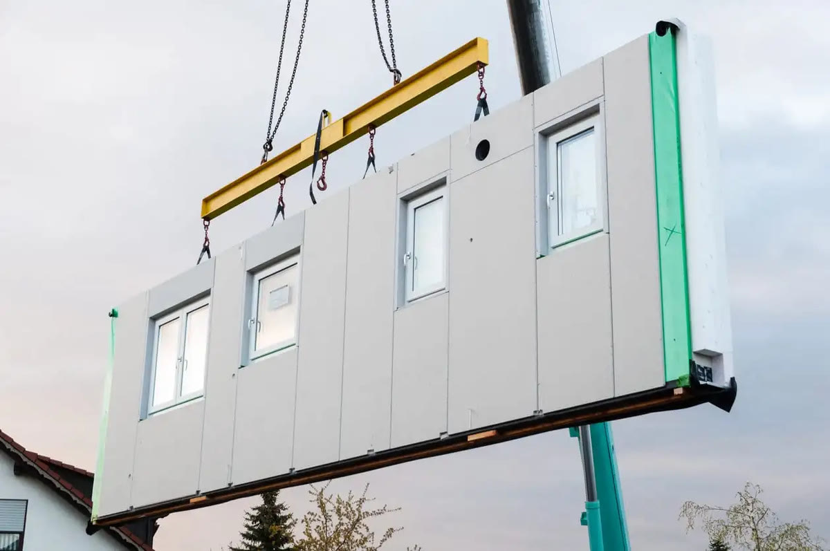 Crane lifting a factory-built module into place